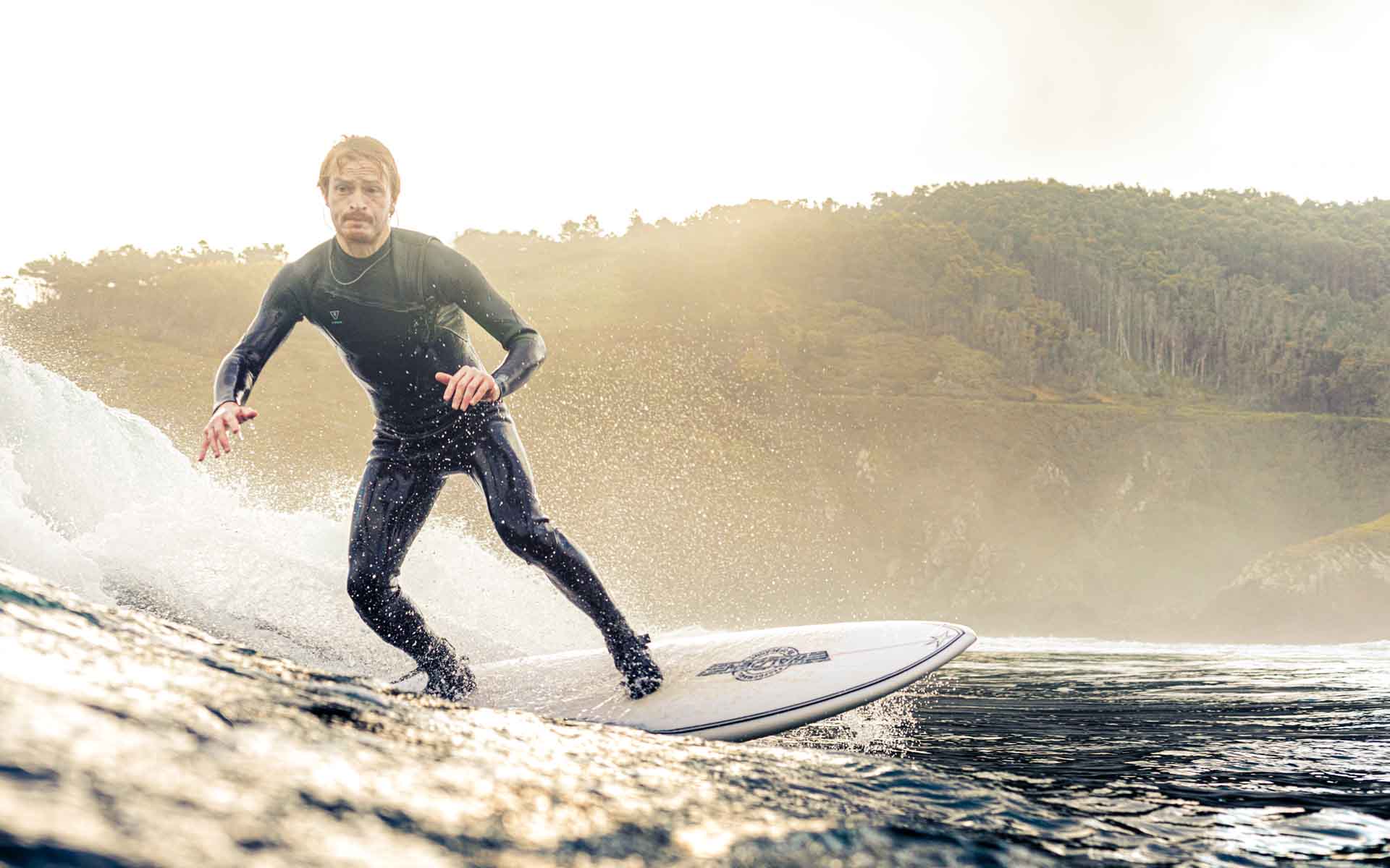 surfer with the sun in the back